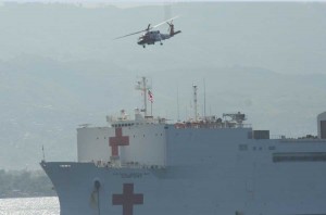 USCG HH-60 helicopter brings injured Haitians to the USNS Comfort for medical treatment January 20, 2010 (Credit Photo: USMC)