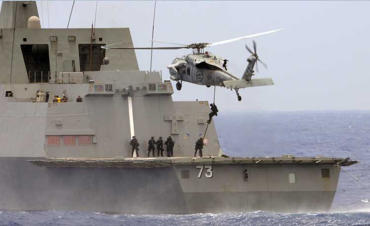US Coast Guardsmen embarked aboard the littoral combat ship USS Freedom conducting a fast-rope descent from an MH-60S Sea Hawk helicopter onto the flight deck of the Republic of Singapore Navy stealth multi-mission frigate RSS Supreme during a maritime security exercise (Credit Photo: USN Visual Service, July 9, 2010)