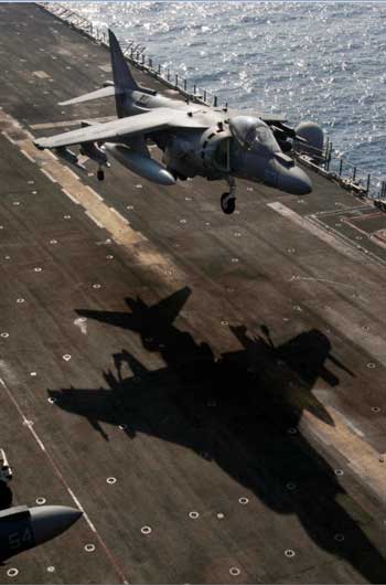An AV-8B Harrier assigned to Marine Medium Tiltrotor (VMM) 162 (Reinforced) participates in a hover exercise off the flight deck of the amphibious assault ship USS Nassau (Credit photo: USN Visual Service, 3/21/10)
