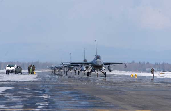 Several F-16 Fighting Falcons taxi down the flight line in a single file line at Eielson Air Force Base, Alaska. RED FLAG-Alaska 08-2 is a Pacific Air Forces command directed field training exercise which provides joint offensive counter-air, interdiction, close air support and large force employment training in a simulated combat environment. The aircraft is assigned to Luke Air Force Base, Ariz.  (Credit: http://air-attack.com/images/single/728/Several-F-16-Fighting-Falcons-taxi-down-the-flight-line.html)