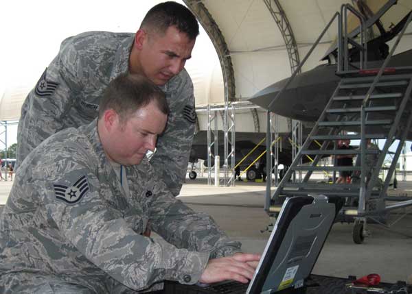 Tech. Sgt. Matthew Burch and Staff Sgt. Jason Westberry, from the 58th Aircraft Maintenance Unit, review post operations tasks on their Portable Maintenance Aid after the fourth F-35 Lightning II taxied into its new home at Eglin. The Airmen are among the first Department of Defense maintainers trained by Lockheed Martin logistics support personnel in the joint strike fighter's recovery and inspection procedures. Both aircraft in the photo arrived here Aug. 31 in a four-ship formation with Lockheed Martin pilots flying the F-35As and F-16 escorts piloted by the wing. (Credit: USAF)