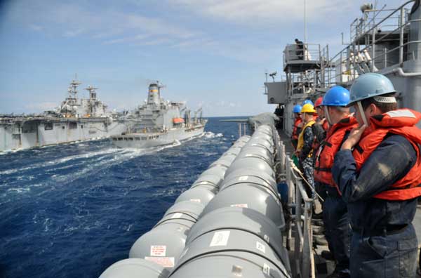 Sailors assigned to the deck department aboard the amphibious transport dock ship USS Ponce (LPD 15) prepare for a replenishment at sea with the fleet replenishment oiler USNS Kanawha (T-AO 196) and the Amphibious assault ship USS Kearsarge (LHD 3).  (Credit: USN Visual Service, 3/10/11)