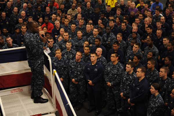 Rear Adm. Kevin Scott, commander of Expeditionary Strike Group 2, addresses sailors aboard the amphibious assault ship USS Wasp in the ship's hangar bay. Wasp was transiting back to Norfolk after standing by to provide assistance in areas affected by Hurricane Irene. (Credit: USN Visual Service, 09/02/11)