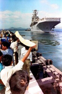Filipino spectators watched the USS Belleau Wood leave Cubi Point as it carried the last group of U.S. marines from Subic Bay Naval Base to Okinawa in November 1992.