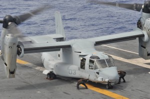 Air department Sailors assigned to the U.S. Navy's forward-deployed aircraft carrier USS George Washington (CVN 73) remove chocks and chains from a U.S. Marine Corps MV-22 Osprey on the flight deck after refueling in support of Operation Damayan. Credit: USN, 11/17/13