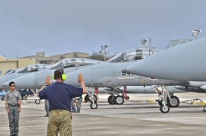 Royal Australian Air Force Leading Aircraftman Steve Bernat, No. 3 Squadron, RAAF Base Williamtown, Australia, marshals an F-15J Eagle from Naha Air Base, Japan during training with Japan Air Self Defense members on the Andersen Air Force Base, Guam flight line during Cope North 2013 Feb 13, 2013. Cope North is an annual air combat tactics, humanitarian assistance and disaster relief exercise designed to increase the readiness and interoperability of the U.S. Air Force, Japan Air Self-Defense Force and Royal Australian Air Force. (U.S. Air Force photo by Staff Sgt. Alex Montes/RELEASED) 