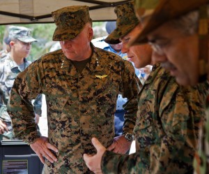 U.S. Marine Sgt. Robert W. Walker, center, explains the capabilities of the miniature deployable assistance water purification system to U.S. Marine Lt. Gen. Terry G. Robling at a disaster site in Biang, Brunei Darussalam, June 19 as part of the Association of Southeast Asian Nations Humanitarian Assistance/Disaster Relief and Military Medicine Exercise (AHMX). The disaster site is the location of the field training exercise portion of the multilateral exercise, which provides a platform for regional partner nations to address shared security challenges, strengthen defense cooperation, enhance interoperability and promote stability in the region. Robling is the commanding general of U.S. Marine Corps Forces, Pacific. Walker is an engineer equipment electrical systems technician with 9th Engineer Support Battalion, 3rd Marine Logistics Group, III Marine Expeditionary Force. 6/19/13 