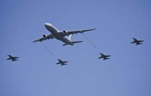 Four F/A-18A Hornets from No. 3 Squadron (SQN) perform a mock air to air refuelling pass with a No. 33 SQN KC-30A Multi Role Tanker Transport aircraft.  This flight demonstration was performed during the Centenary of Military Aviation Air Show at RAAF Williams - Point Cook, (held in early March 2014) commemorating 100 years of military aviation in Australia. Credit: RAAF 