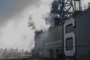 he future amphibious assault ship USS America (LHA 6) fires its portside 40-mm saluting battery, during a 21-gun salute evolution as the ship arrives in its homeport of San Diego for the first time. USS America, 9/15/14