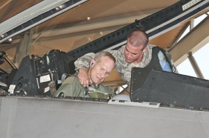 U.S. Air Force Staff Sgt. Joshua Bard, a crew chief with the 43rd Aircraft Maintenance Unit, straps in Gen. Mike Hostage, commander of Air Combat Command, into an F-22 Raptor for his qualification flight at Tyndall Air Force Base, Fla. (U.S. Air Force photo by Christopher Cokeing/Released) 