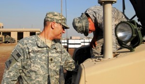 Navy Commander Ed Fischer (left) and Air Force 1st Lt. E.J. Wong inspect an Warlock equipped Humvee in Iraq, 11/8/08.On a day-to-day basis, electronic threats to the U.S. military change; therefore, the solutions or the means of fighting that threat change. For the ever changing electronic threat, the Army looked to the Navy and Air Force for their expertise. 2nd Brigade Combat Team, 1st Armored Division. 