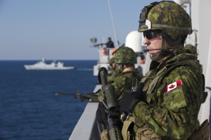 Canadian soldiers stand force protection watch during Coral Strait passage aboard the Royal Netherlands Navy landing platform dock ship HNLMS Johan de Witt (L801) as the Danish frigate HDMS Niels Juel (F363) transits alongside for air threat protection during Bold Aligator 2014.(U.S. Navy photo courtesy of the Royal Netherlands Navy by SMJR Gerben van Es/Released) 