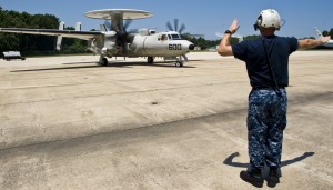 130716-N-OY799-099  PATUXENT RIVER, Md. (July 16, 2013) Aviation Structural Mechanic 1st Class Stephen Swett, assigned to the Pioneers of Air Test and Evaluation Squadron (VX) 1, signals for the start up of an E-2D Hawkeye on the flight line. (U.S. Navy photo by Mass Communication Specialist 2nd Class Kenneth Abbate/Released)