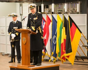 SNMCMG1 - Hand-over ceremony in Den Helder NETHERLANDS -  Commodore Minderhoud adressing SNMCMG1 crew - 22 JAN 2015 photo by WO C.ARTIGUES (HQ MARCOM). Lithuanian Navy Commander Giedrius Premeneckas handed over command of Standing NATO Mine Counter-Measures Group one (SNMCMG1) to Dutch Navy Commander Peter A.J. Bergen Henegouwen during a brief Ceremony conducted by NATO Allied Maritime Command's deputy Chief of Staff Operations Commodore Arian Minderhoud.              Standing NATO Mine Countermeasures Group 1 (SNMCMG1) is a multinational, integrated maritime force made up of vessels from various allied countries. These vessels (including their helicopters) are permanently available to NATO to perform different tasks ranging from participating in exercises to actually intervening in operational missions. These groups provide NATO with a continuous maritime capability for operations and other activities in peacetime and in periods of crisis and conflict. They also help to establish Alliance presence, demonstrate solidarity, conduct routine diplomatic visits to different countries, support transformation and provide a variety of maritime military capabilities to ongoing missions.