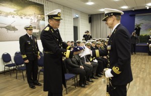 Hand-over ceremony in Den Helder NETHERLANDS - Commodore Minderhoud offering a NATO flag to new COM SNMCMG1 Commander Bergen Henegouwen - 22 JAN 2015 photo by WO C.ARTIGUES (HQ MARCOM). Lithuanian Navy Commander Giedrius Premeneckas handed over command of Standing NATO Mine Counter-Measures Group one (SNMCMG1) to Dutch Navy Commander Peter A.J. Bergen Henegouwen during a brief Ceremony conducted by NATO Allied Maritime Command's deputy Chief of Staff Operations Commodore Arian Minderhoud. Credit: NATO 