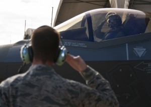 Maj. Gen. Jay Silveria, U. S. Air Force Warfare Center commander, salutes his crew chief, Airman 1st Class Patterson, 33rd Aircraft Maintenance Squadron, as he begins taxiing for his final qualifying flight in the F-35A Lightning II Sept. 26 at Eglin Air Force Base, Fla.  Silveria became the first general officer in the Department of Defense to qualify in the fifth generation fighter.  He completed his training with back-to-back flights and hot pit refueling.  (U.S. Air Force photo/Samuel King Jr.) 
