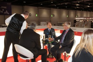 Tim Gibson and Eric Bowles talking with Admiral Graham Howard, thenUK MoD Assistant Chief of Staff for Logistics Operations at the DSEI Show in 2013. Credit: Fujitsu 