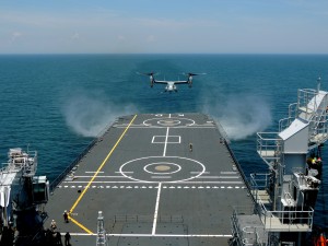 An MV-22 Osprey with Marine Medium Tiltrotor Squadron 261 prepares to land onto the Karel Doorman, a Dutch warship, during an interoperability test near Marine Corps Air Station New River, N.C., June 12, 2015.  The unit worked jointly with the Royal Netherlands Navy to perform the first MV-22 Osprey carrier landing aboard a Dutch warship and strengthened the existing partnership between the two countries.  II Marine Expeditionary Force 