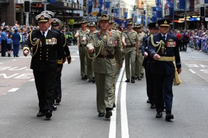 Senior Defence leaders (L-R) Commander Australian Fleet, Rear Admiral Stuart Mayer, CSC & Bar RAN, Commander Forces Command, Major General Peter Gus Gilmore AO, DSC, and Air Commander Australia, Air Vice-Marshal Gavin Turnbull lead the 2015 Anzac Day march through Sydney. Approximately 2240 ADF members are currently deployed on operation, continuing the Anzac spirit whilst serving Australias national interests at home and in many countries around the world. Credit: Australian Ministry of Defence 