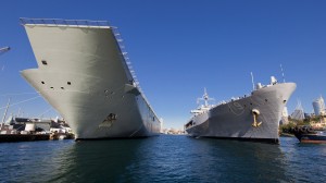 USS Blue Ridge (right) moves into postition behind Australia's newest and largest ship, HMAS Canberra, at Garden Island Naval Base in Sydney. *** Local Caption *** The command ship of the U.S. Navy 7th Fleet, USS Blue Ridge (LCC 19), and the embarked U.S. 7th Fleet staff, arrive in Sydney on 3 July 15 for a port visit. USS Blue Ridge is a command and control ship and is forward deployed to Commander Fleet Activities, Yokosuka, Japan.  Blue Ridge is visiting Sydney ahead of 5Exercise Talisman Saber 2015.