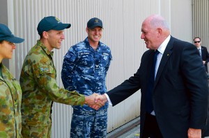 The Governor-General, His Excellency General the Honourable Sir Peter Cosgrove AK MC (Retd) greets Leading Aircraftman Kieran Ferguson from No 77 Squadron during a visit to RAAF Base Williamtown. February 3, 2015. 