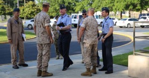 Col. Peter D. Buck and Col. Robert D. Cooper greet United Kingdom Royal Air Force officers Air Commodore Harvey Smyth, Group Capt. Paul Godfrey, and Group Capt. Ian Townsend as they arrive at Headquarters and Headquarters Squadron, June 16, 2015. 