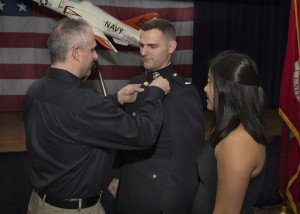 1st Lt. Taylor Zehrung has his Wings of Gold put on by his father Steve while his sister Aimee looks on during Training Air Wing Two’s winging ceremony and becomes the first naval aviation student selected to fly the F-35 Lightning II.