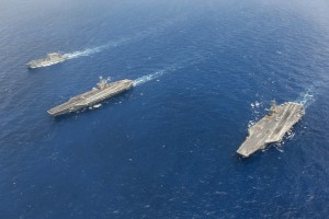 The dry cargo and ammunition ship USNS William McLean (T-AKE 12), left, and the aircraft carriers USS Harry S. Truman (CVN 75), center, and USS Theodore Roosevelt (CVN 71) steam through the Atlantic Ocean July 16, 2014. The ships were underway conducting an ammunition transfer. (U.S. Navy photo by Mass Communication Specialist 3rd Class Karl Anderson/Released) 