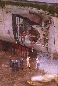 Officials survey the damage of USS Tripoli while the ship was in drydock in Bahrain following a mine attack. US Navy Photo