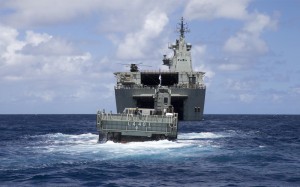 A Royal Australian Navy Landing Craft approaches HMAS Canberra off the coast of Koro Island, Fiji. *** Local Caption *** On Tuesday March 01, HMAS Canberra steamed towards cyclone devastated Koro Island to assist with the Fiji Government's disaster relief effort. Australian Defence Force (ADF) elements together with personnel from the Department of Foreign Affairs and Trade (DFAT) flew ahead from the ship via MRH-90 helicopter to meet with Koro Island local authorities in preparation for Canberra's arrival. Commanding Officer, 2nd Combat Engineer Regiment (2CER) toured the island with DFAT and local Fijian authorities to meet and discuss needs with village leaders. Concurrently, reconnaissance sections from 2nd Battalion Royal Australian Regiment (2RAR) conducted a survey of the island to assess the condition of roads, houses, schools and other infrastructure. Information gathered will be used to set the priorities for HAMS Canberra's capability, including amphibious and engineering assets as well as specialist engineer personnel to help carry out repair work. 
