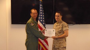 Col. Christopher Niemi, 33rd Operations Group commander, presents U.S. Marine Corps 1st Lt. Samuel Winsted, F-35B Lightning II intelligence officer, a graduation certificate after completing the F-35 Intelligence Formal Training Unit course, June 24, 2015, on Eglin Air Force Base, Fla. Winsted will serve in a critical role assisting the Marine Corps’ F-35 program at Marine Corps Air Station Yuma, Ariz., as it becomes the first operational F-35B base. The Marine Corps will declare IOC with the F-35B, short take-off and vertical landing variant, this summer. (U.S. Air Force courtesy photo) 