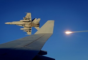 A Royal Australian Air Force F/A-18 Hornet strike fighter fires a flare while banking away from a RAAF KC-30A Multi-Role Tanker Transport aircraft over the skies over Iraq. *** Local Caption *** A Royal Australian Air Force KC-30A Multi-Role Tanker Transport aircraft enables Air Force to conduct air-to-air refuelling of Australian F/A-18A Hornets and other coalition aircraft over Iraq. Air-to-air refuelling is essential for ensuring Coalition aircraft can remain on-station for as long as possible to conduct or support close air support and precision strike operations in support of Iraqi Security Forces. The Air Task Group, part of Australias Operation OKRA, comprises six F/A-18 Hornet strike aircraft, a KC-30A Multi-Role Tanker Transport and an E-7A Wedgetail Airborne Early Warning and Control aircraft. They participate in air operations in Iraq and Syria as part of the international coalition formed to disrupt and degrade the Daesh threat. 