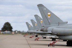 Discription: Typhoon aircraft relocate to RAF Lossiemouth Number 1 (Fighter) Squadron marks relocation with a special 8-ship formation in the shape of a number 1. Relocating from RAF Leuchars in Fife, Scotland, to RAF Lossiemouth, Typhoon aircraft of 1 (Fighter) Squadron will now provide quick reaction alert (QRA) cover alongside the Typhoons of 6 Squadron for the north of the UK. Quick reaction alert for the south will be based at RAF Coningsby. Air Officer Scotland and station commander at RAF Leuchars, Air Commodore Gerry Mayhew, said: “As the Typhoon aircraft and personnel of 1 (Fighter) Squadron begin their timely relocation to RAF Lossiemouth, it is fitting for us to pause and celebrate over 100 years of outstanding military aviation history at RAF Leuchars. “From its humble beginnings as a balloon station, Leuchars grew throughout the Second World War and beyond to become one of the United Kingdom’s foremost air defence stations. It’s exemplary record as the home of northern QRA stands as a testament to the professionalism and dedication of our people.” Speaking about the future of his squadron, officer commanding 1 (Fighter) Squadron, Wing Commander Mark Flewin, said: “The relocation of an entire fast-jet squadron is a phenomenal achievement and it is testament to the commitment, flexibility and capability of all personnel involved that it was carried out so successfully. “1 (Fighter) Squadron is delighted to have arrived at RAF Lossiemouth and now looks forward to continuing its quick reaction alert duties alongside 6 Squadron.” As for the future of RAF Leuchars, it will now focus on becoming home to army units the Royal Scots Dragoon Guards, 2 Close Support Battalion of the Royal Electrical and Mechanical Engineers, and 110 Provost Company of the Royal Military Police in 2015. Brigadier Paul Harkness, Commander 51st Infantry Brigade and Headquarters Scotland, said of the army’s move to Leuchars: “We are delighted to have such a good l 