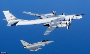 A British Typhoon jet, bottom, is seen intercepted one of two Russian 'Bear' aircraft that were spotted flying in international airspace September 2014. Credit Daily Mail 