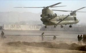 Fuelers from Company E, Task Force Comanche, 4th Combat Aviation Brigade, 4th Infantry Division prepare to refuel a CH-47 Chinook at a Spanish run FOB. This FOB is the location of one of TF Comanche’s forward arming and refueling points where Soldiers have pumped approximately a half million gallons of fuel since their deployment began in June.
